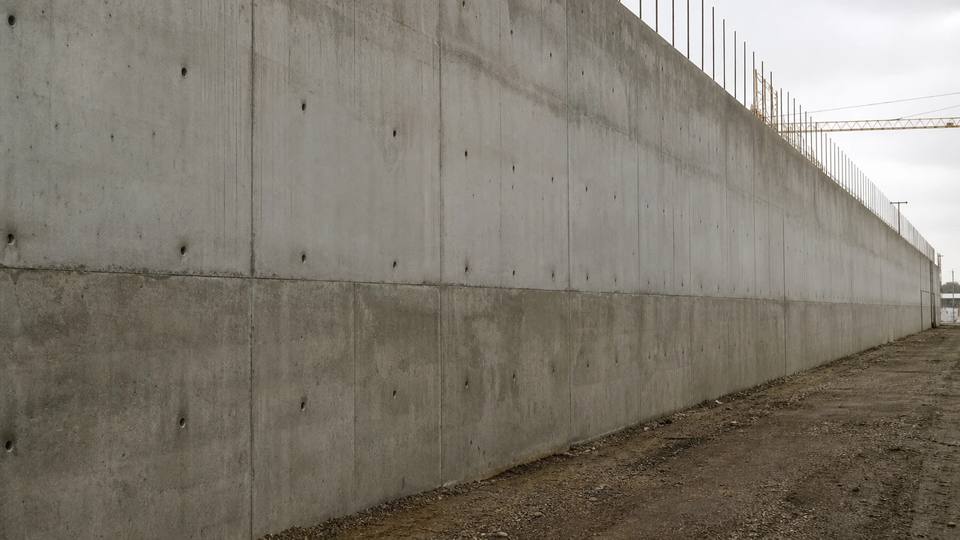 Монолитная бетонная стена промышленного здания на всю высоту с рабочим швом